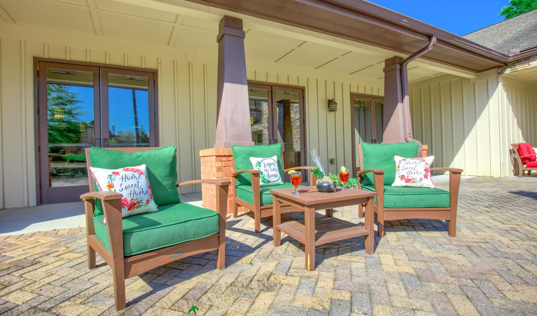 Settle into comfort at King's Reserve Suwanee a patio with chairs and a table