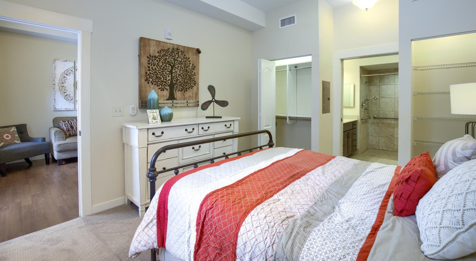 Relax and recharge in beautiful and spacious bedrooms a bedroom with a bed and a dresser