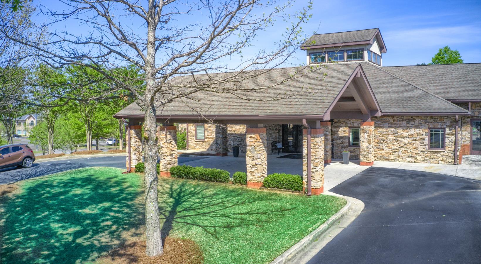Find your perfect fit at King's Reserve Suwanee a house with a driveway and a tree in front of it